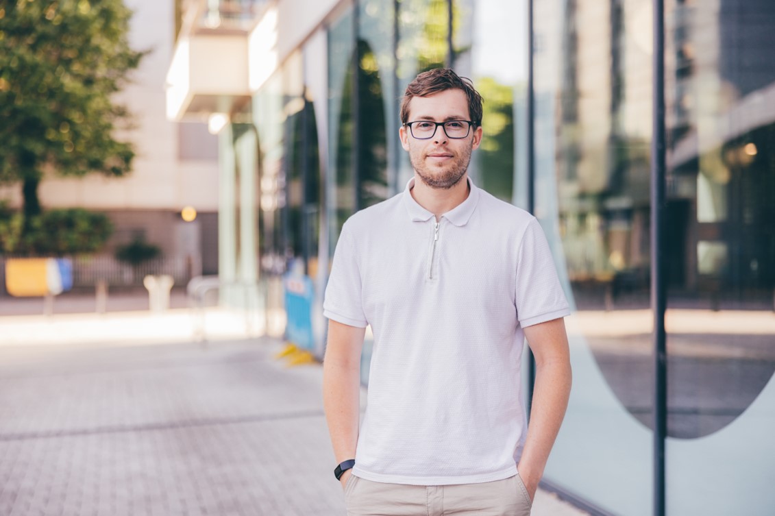 photo of the new chair of the BID standing in the high street wearing a white polo shirt.